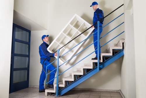 Removal team handling access challenges on stairs in a London property