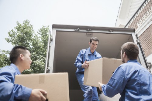 Moving team handling boxes near Clapham Junction residential streets
