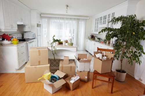 Removal team loading household items into a van