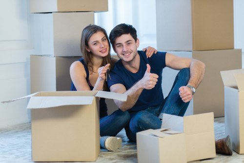 Professional movers carrying furniture through a flat entrance