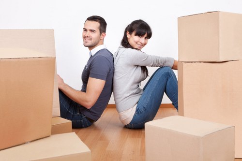 Professional movers transporting furniture for a flat relocation