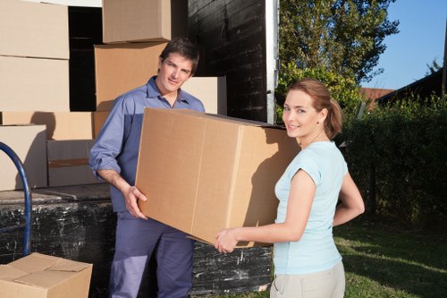 Local movers carefully wrapping fragile belongings before transport